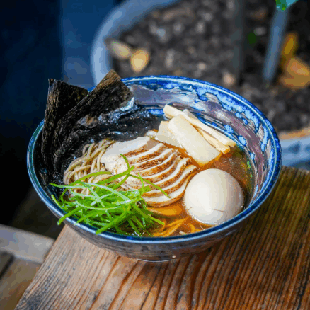 Maneki Ramen’s classic shoyu ramen — silky noodles in savory soy-based broth, topped with chashu pork, seasoned egg, bamboo shoots, nori, and fresh scallions.